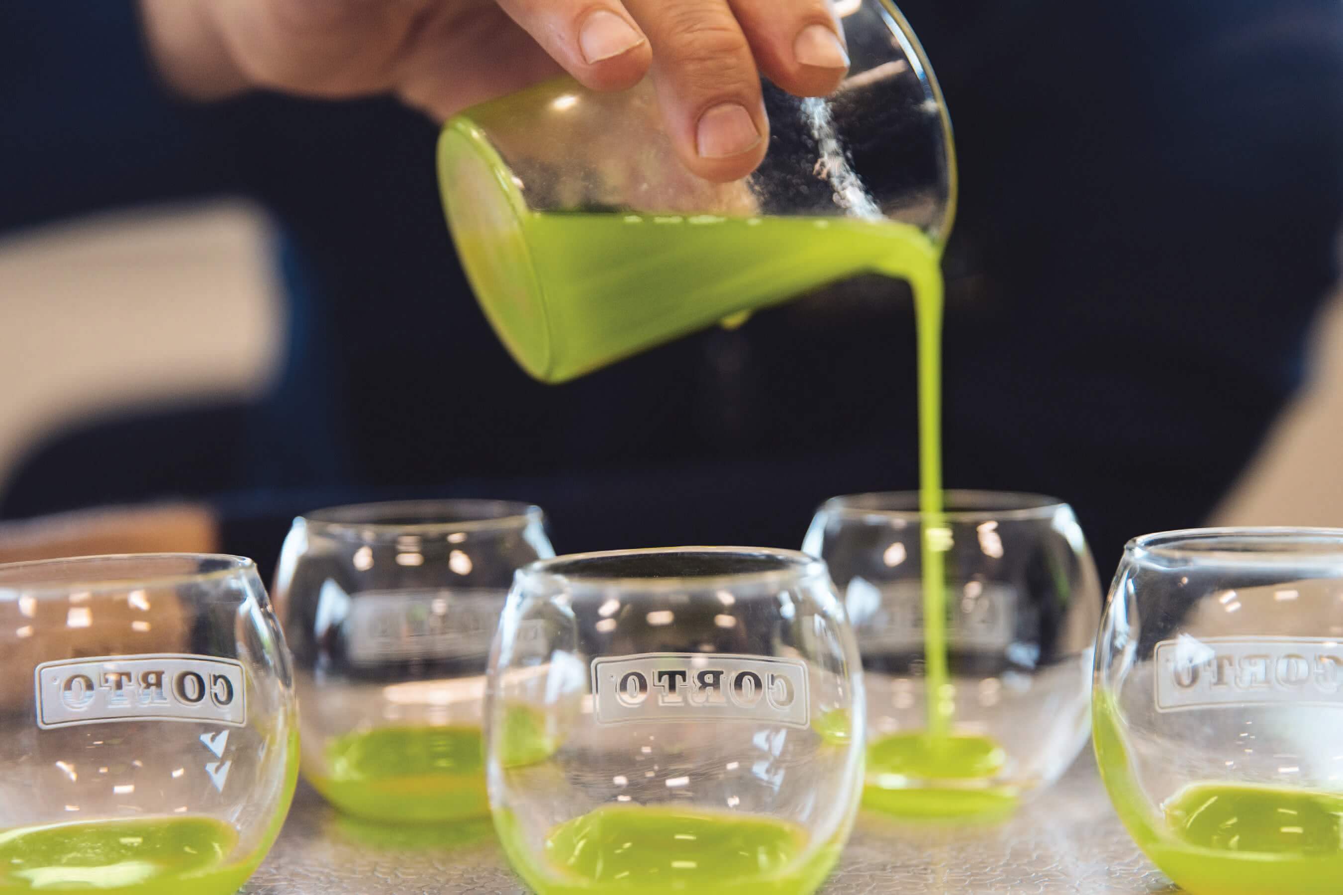 Hand pouring bright green liquid