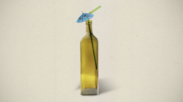 olive oil bottle with an umbrella cocktail