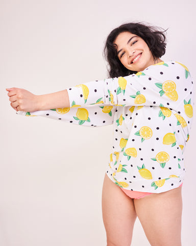 Model posing in a lemon print sweatshirt