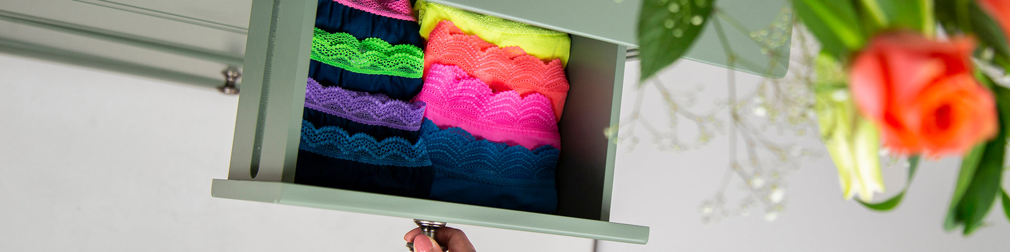 An open drawer with folded knickers inside