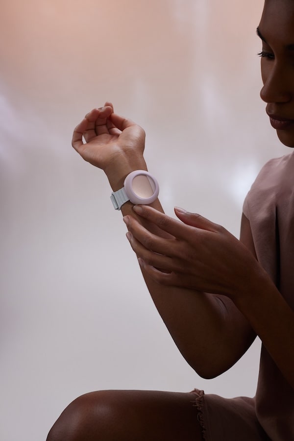 Woman wearing an Embr Wave her wrist.