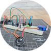 Breadboard circuit on grey engineering mat