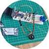 Breadboard circuit with spearker on green engineering mat