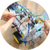 Hands working on robot with breadboard circuit