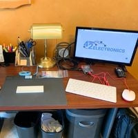 Desk with 42 Electronics website on computer monitor and breadboard circuit on desk