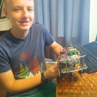 Teen showing off robot he built