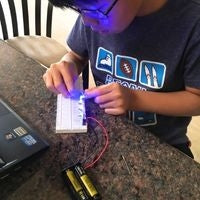 Student building breadboard circuit