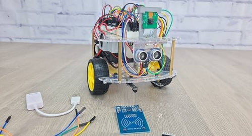 Robot sitting on table with assorted electronic components