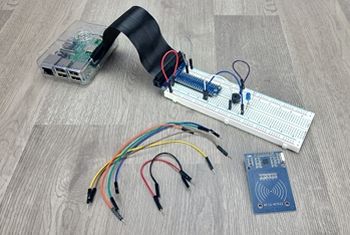 Breadboard circuit with a few basic components; RFID reader and jumper wires on table