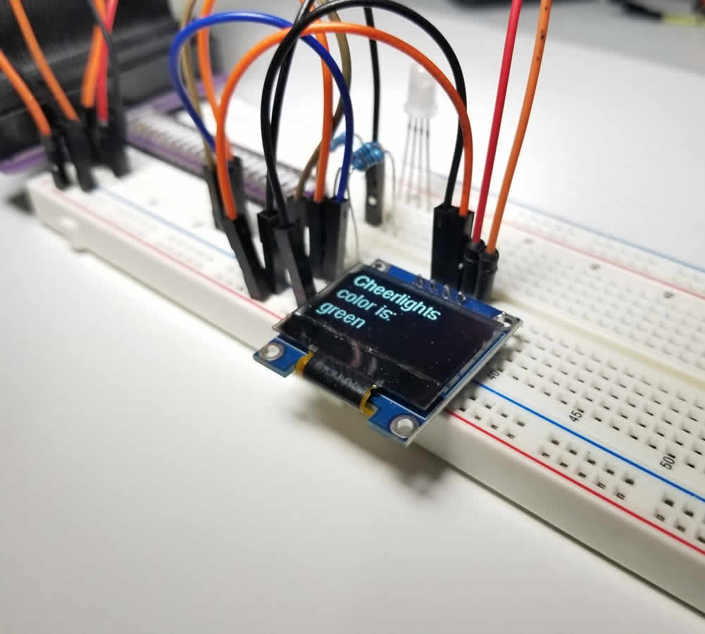Breadboard circuit featuring OLED screen and jumper wires