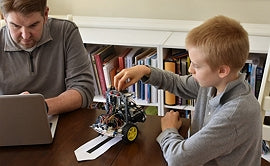 Man and Boy working on robot