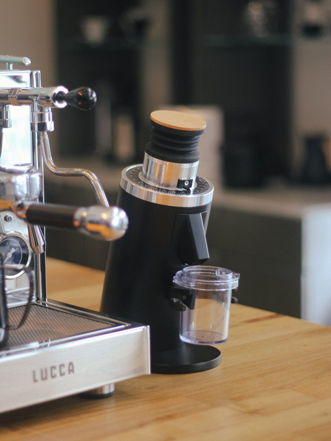 A Black DF 54 All Purpose grinder next to the LUCCA X58 Espresso Machine