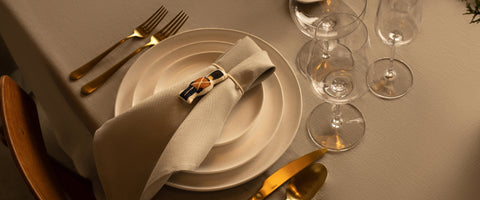 Fable Dinner Plates in white with a nutcracker napkin holder and white napkin on top.