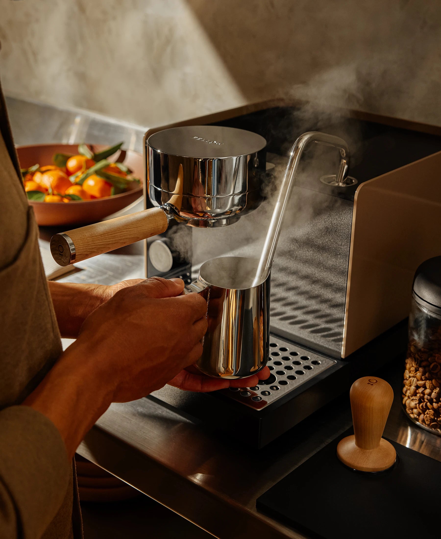 Using the assisted steaming wand to create silky milk