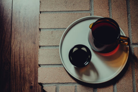 Clean coffee set-up featuring the Kinto Sepia Jug, Kinto Ceramic Lab Plate, and NotNeutral Vero Glass