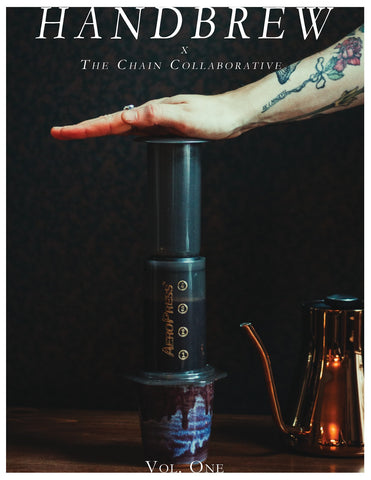 Pressing an Aeropress on the cover of Handbrew Publication