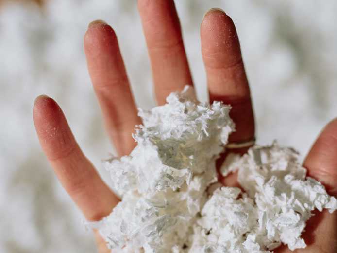 Hand holding the Tencel wood pulp fiber used in the TreeBlend material.