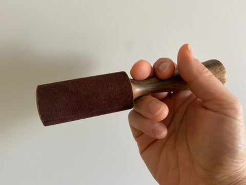 Singing bowl mallet wrapped around fingers