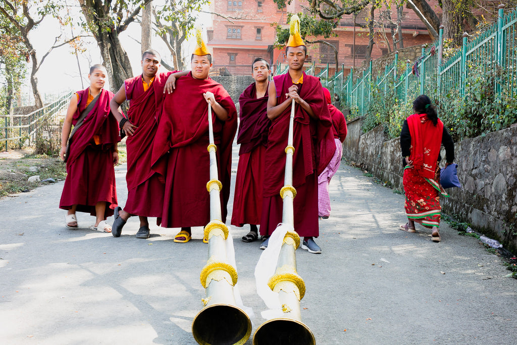 Young Buddhist monks with Tibetan horn