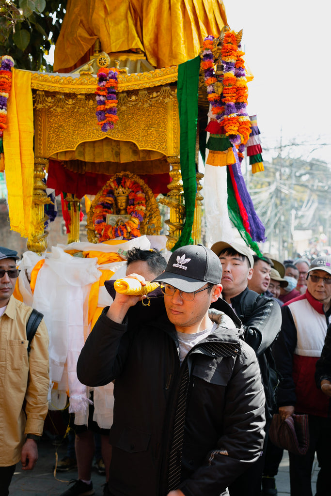 Holding the Buddha Maitreya palanquin