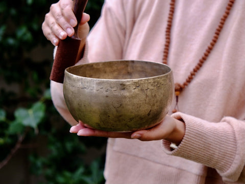 Tibetan singing bowl being struck