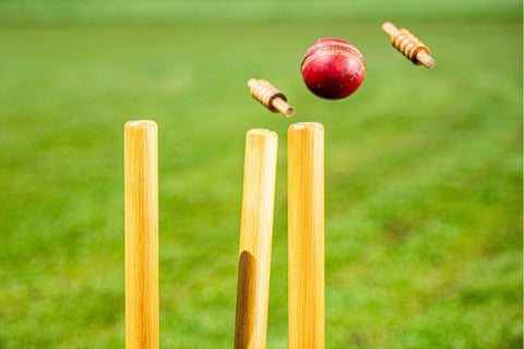 How tall are cricket stumps featuring a ball knocking the bails off a set of stumps