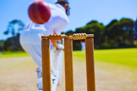 How tall are cricket stumps featuring a batsman missing a ball that nearly hits the stumps