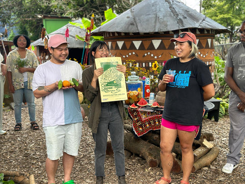 Minh Tran, Thao Tran, and Amanda Chan of VietLead presenting Bitter Melon