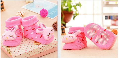 pair of socks with pink fabric rabbit sewn on top