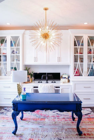 home office bold chandelier and bight blue desk