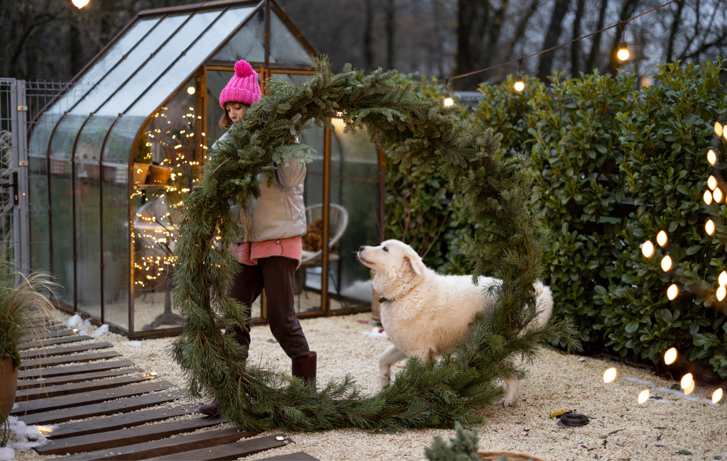 woman and her dog with giant Christmas wreath DIY wreath