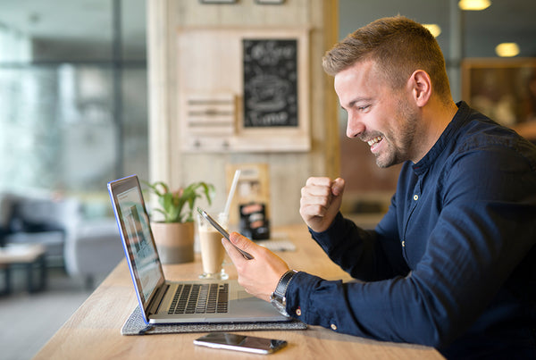 man excited about marketing working on his computer