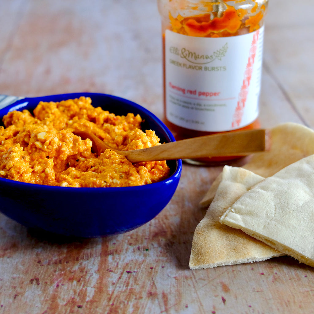 tyrokafteri in a bowl with pitta chips