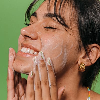 Close up of a young woman touching her skin