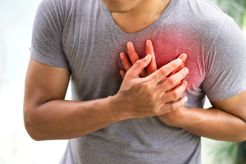 Man clutching his heart in pain
