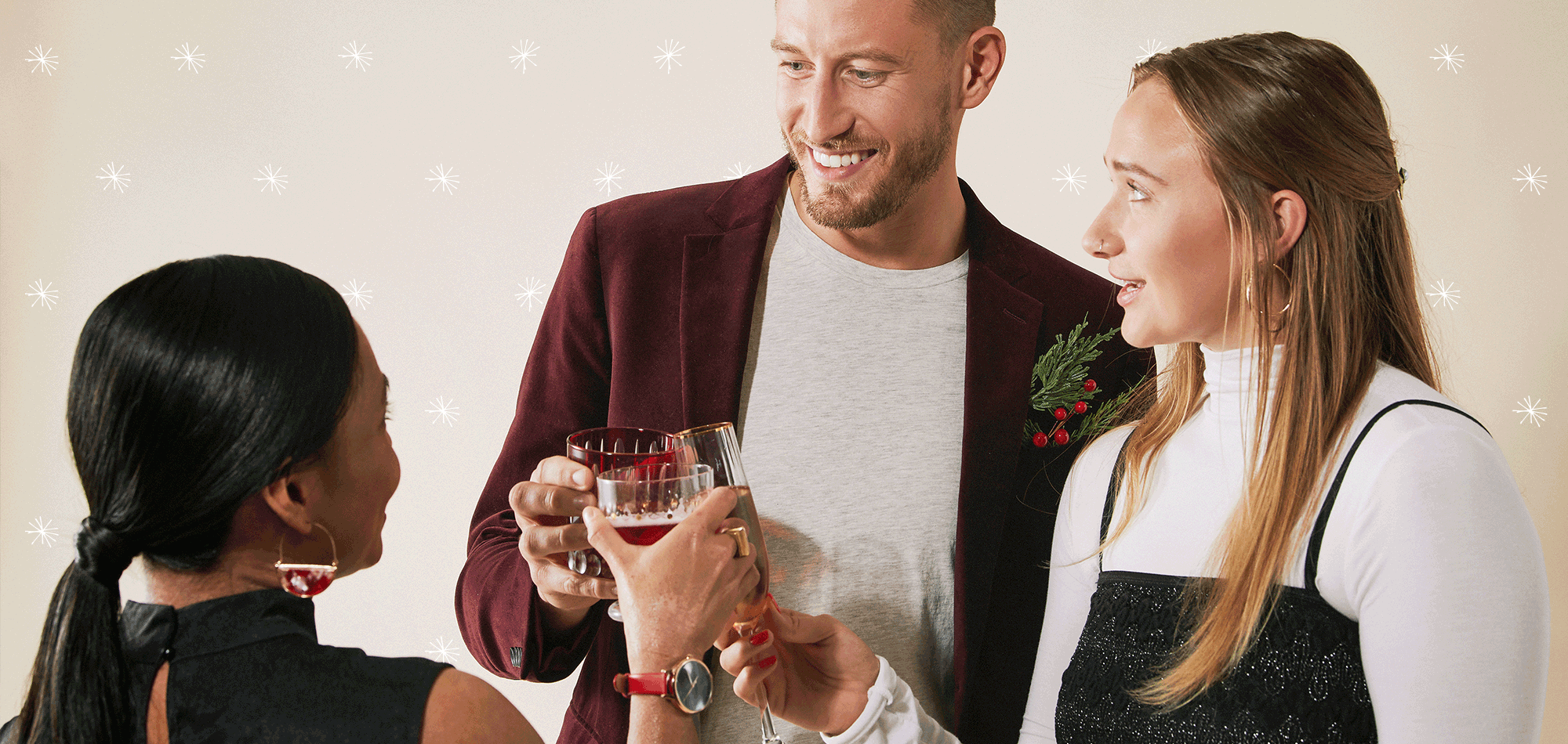 Image of Laura, Matt, and Haley toasting their drinks while wearing festive, holiday clothing
