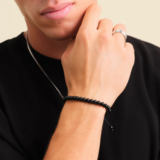 What does a black beads bracelet mean on a man in 2024?