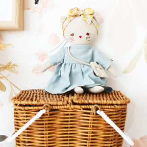 Alimrose Mini Lilly Kitty Grey Linen in medium sitting on a rattan basket 