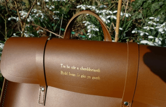 Leather bag with embossing completed on it in collaboration with the Welsh Choir 