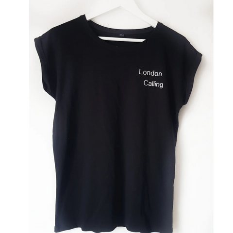 Plain black crew neck tee with white writing on left chest pocket area that says London Calling