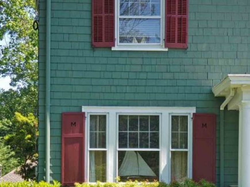 teal house with dark red shutters