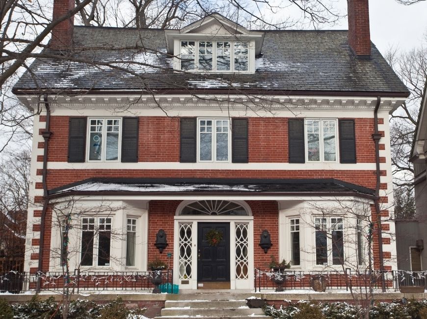 red brick home with black shutters