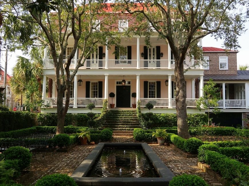 light pink house with reflecting pond