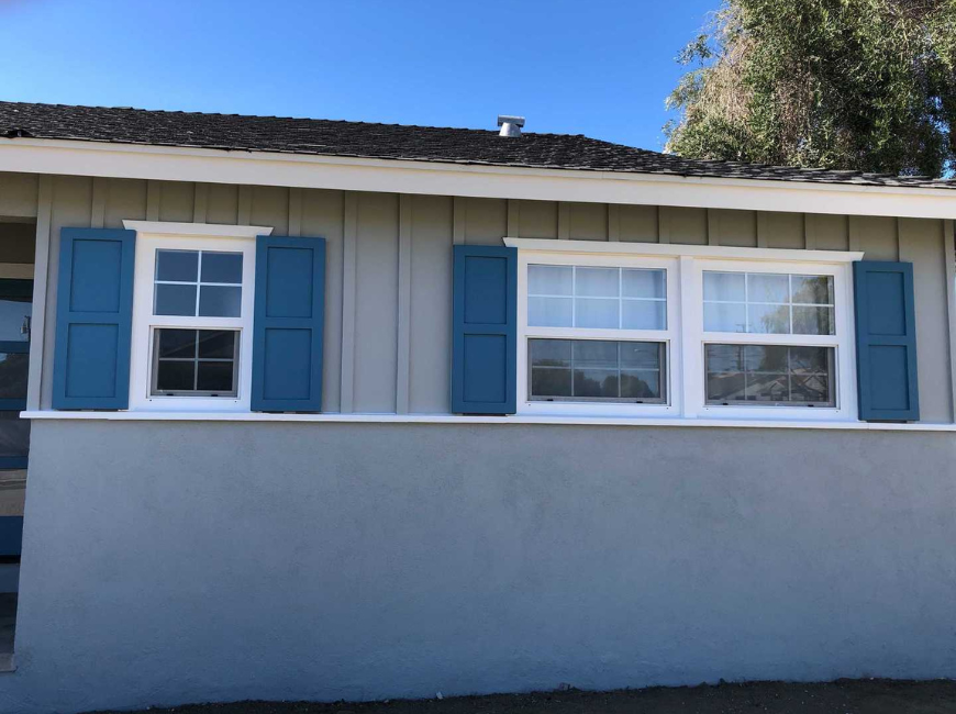 house with windows blue shutters oversized window