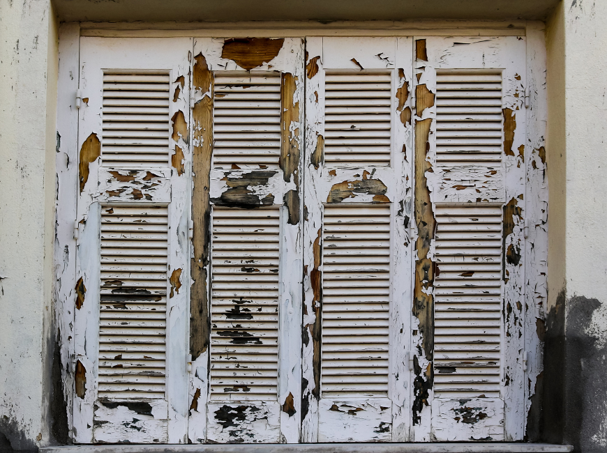 white chipped and cracked shutters