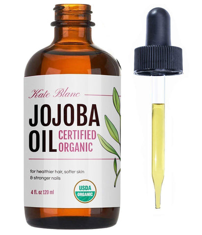 amber bottle of jojoba oil with dropper