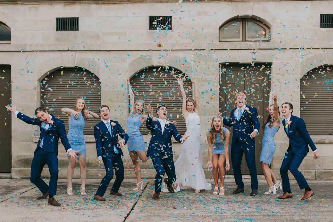 Bioconfetti Bridal Party throwing Confetti in front of building