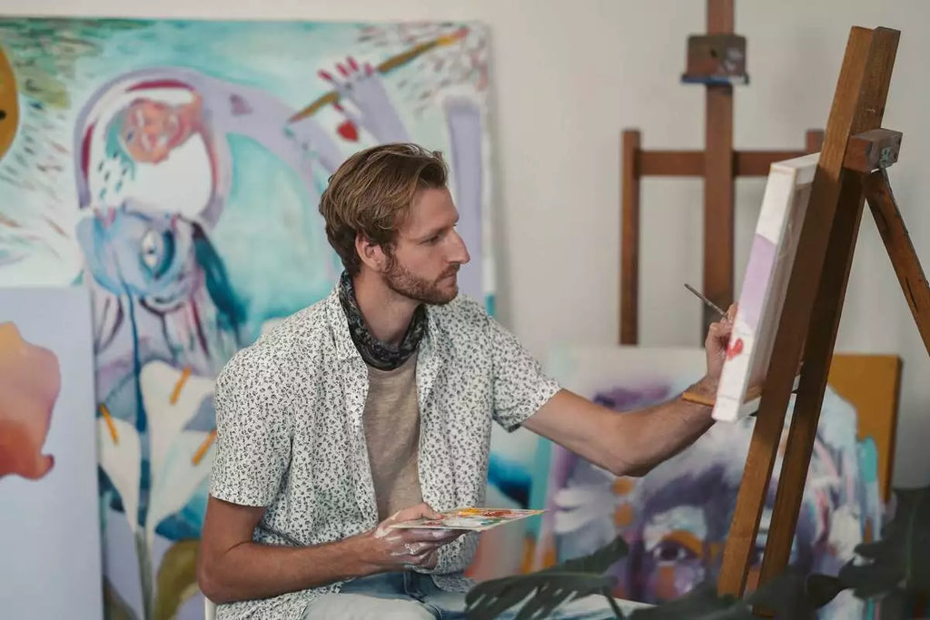 Young man painting DIY canvas art