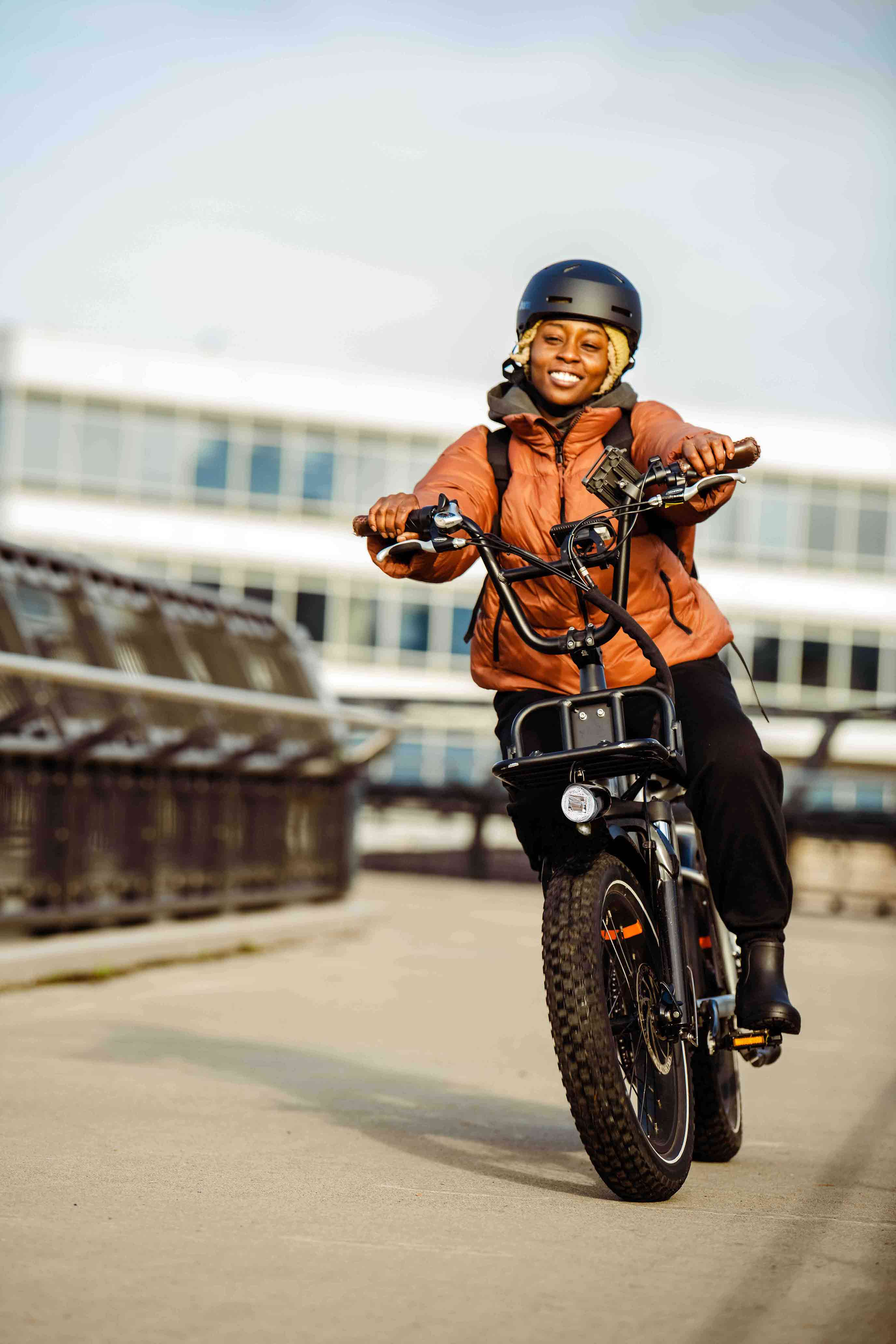 Seattle-photographer Nicole rides her RadRunner Plus down a paved bridge.