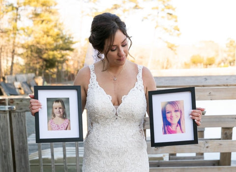 Echelon Member Melissa S. on her wedding day holding photos of her two transplant donors